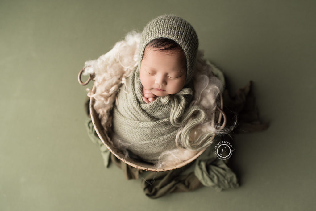 Green swaddled baby